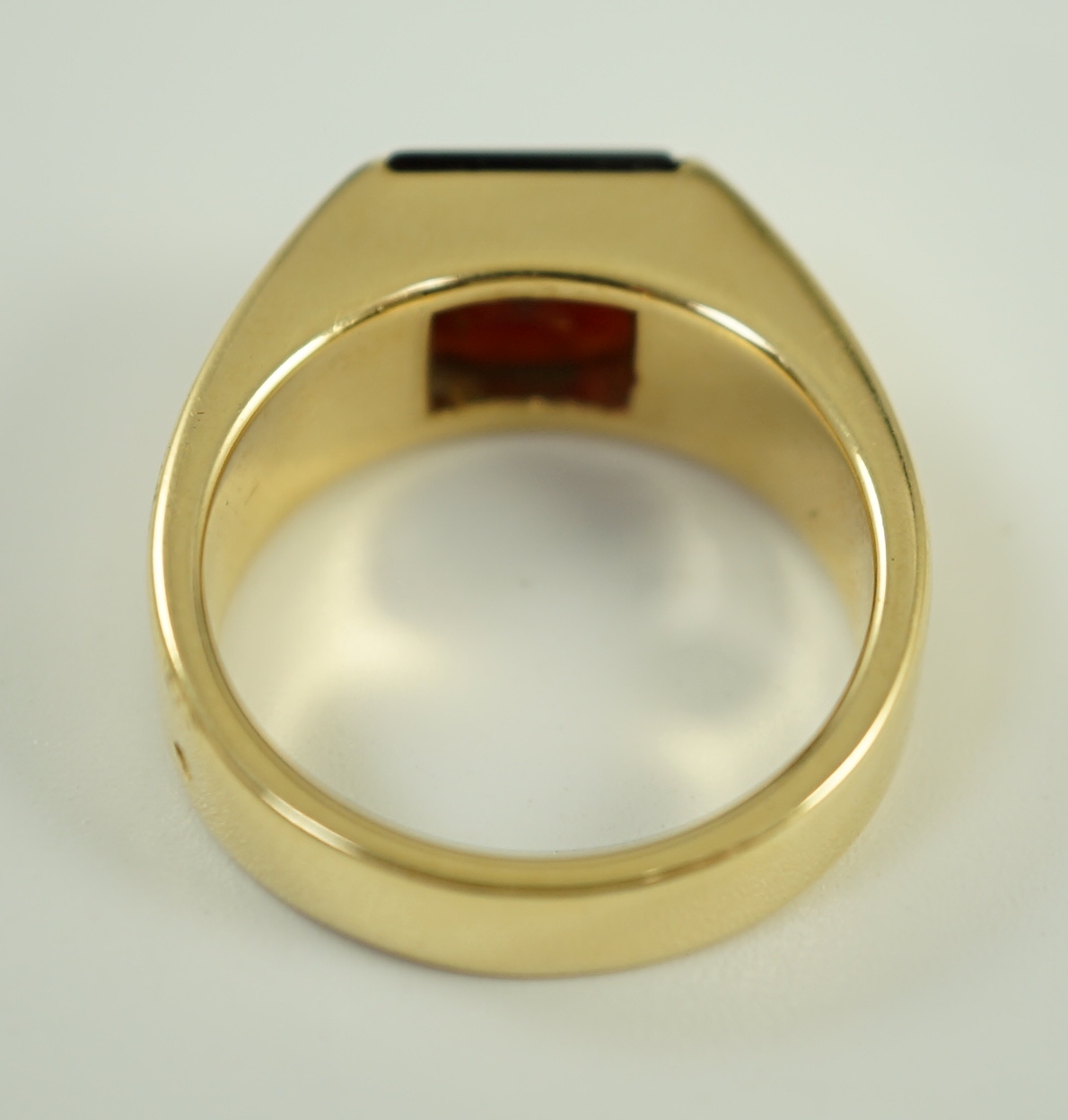 A gentleman's 1990's Cartier 18ct gold and gypsy set garnet ring